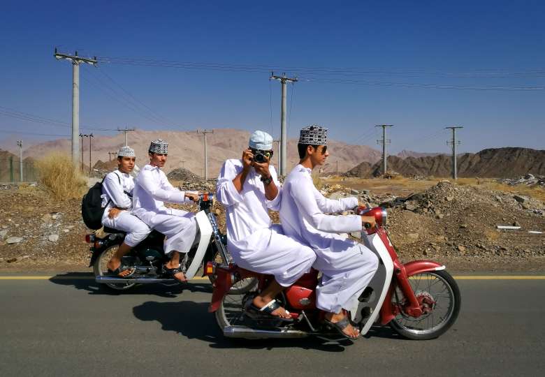 Highschool boys heading home, in Oman. Photographed by Tasneem Alsultan